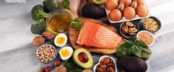 Healthy high protein foods like salmon, eggs, avocado, broccoli, nuts and legumes arranged on a table for balanced nutrition